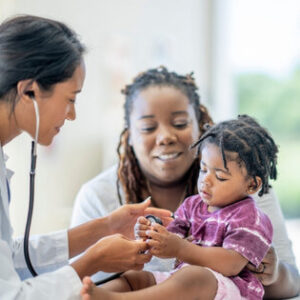 Doctor examining a young child during a family medicine appointment