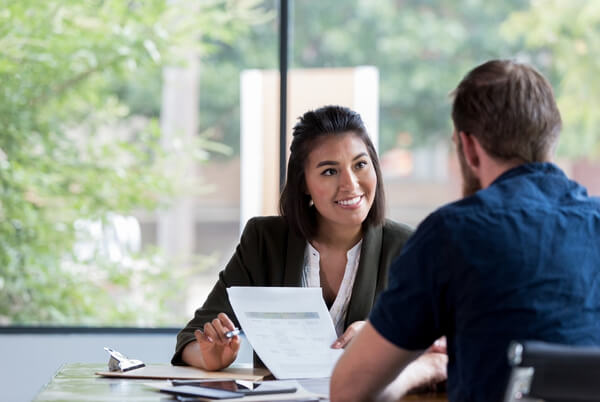 Workplace health professional discussing a document with an employee