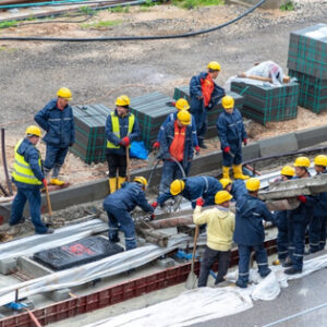 Workers wearing hard hats and safety clothing at a rail construction site