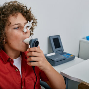 Patient breathing into a spirometer during a lung function test
